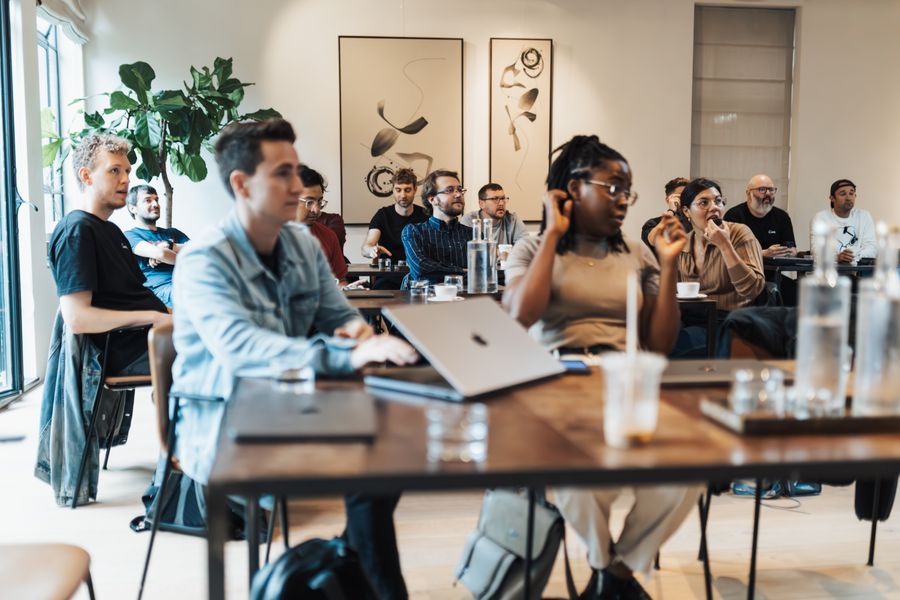 A diverse group of adults taking part in a workshop in a modern office